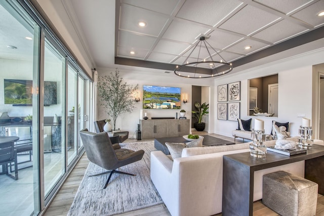 living room featuring light hardwood / wood-style floors, a chandelier, and coffered ceiling