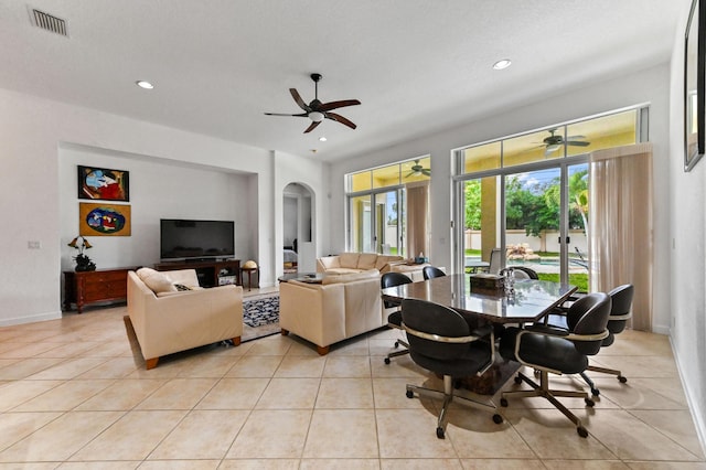 tiled living room with ceiling fan