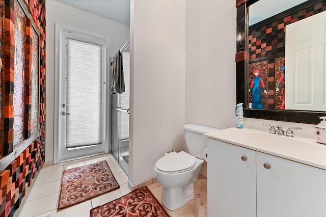 bathroom with toilet, an enclosed shower, tile patterned flooring, and vanity