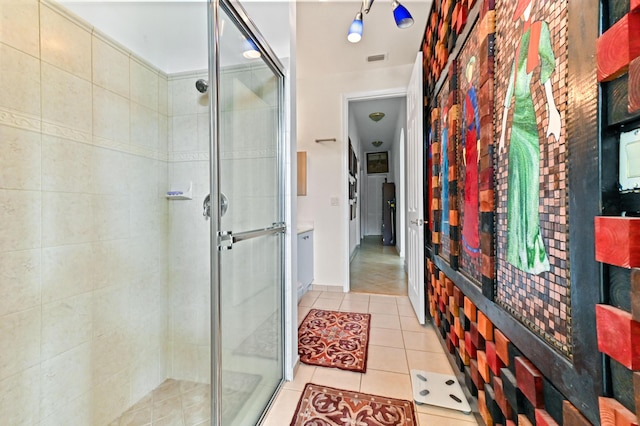 bathroom featuring tile patterned flooring and an enclosed shower