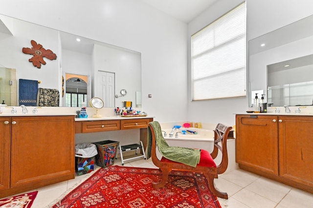 bathroom featuring a washtub, vanity, and tile patterned floors