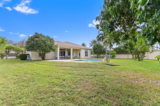 exterior space with a yard, a fenced in pool, and a patio