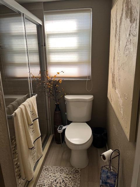 bathroom featuring hardwood / wood-style flooring and toilet