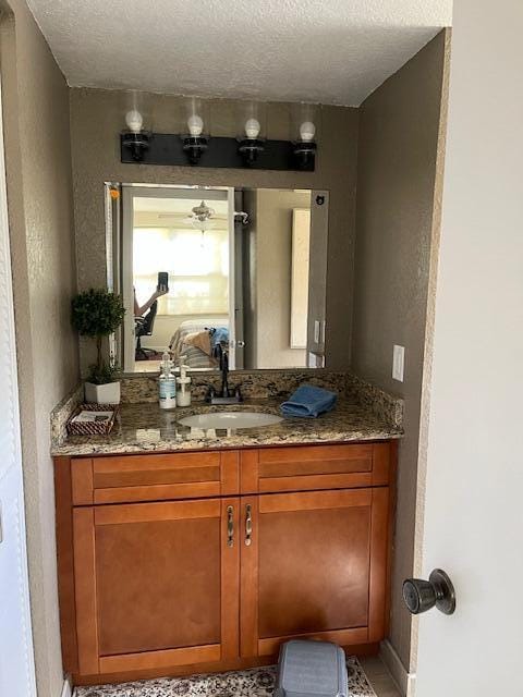 bathroom with vanity and a textured ceiling