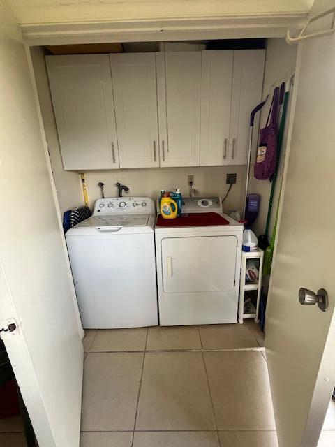 washroom featuring tile patterned floors, cabinets, and independent washer and dryer