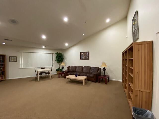 carpeted living room with lofted ceiling