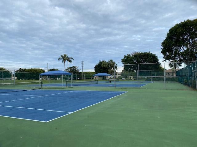 view of tennis court featuring basketball hoop