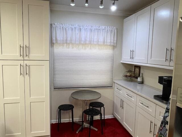 kitchen featuring refrigerator and white cabinetry