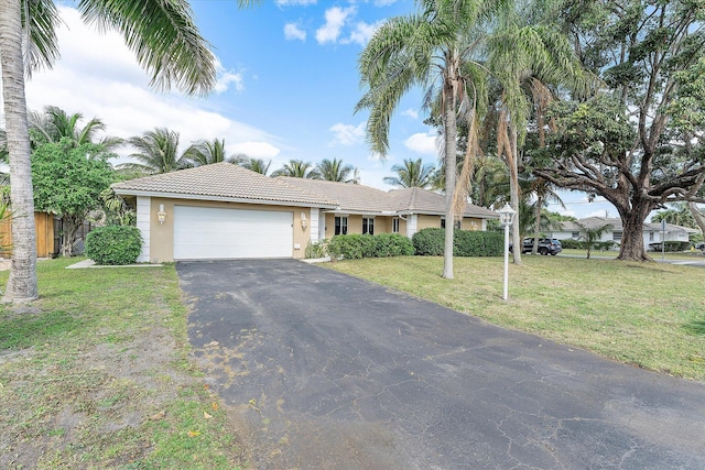 ranch-style house featuring a garage and a front yard