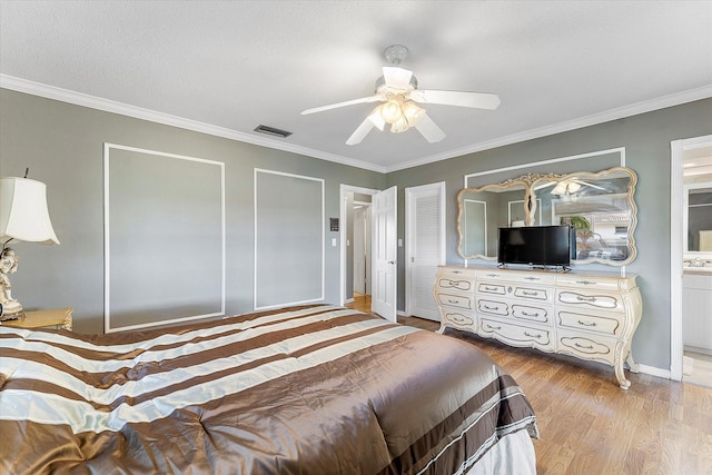 bedroom featuring ceiling fan, light hardwood / wood-style floors, crown molding, and ensuite bath