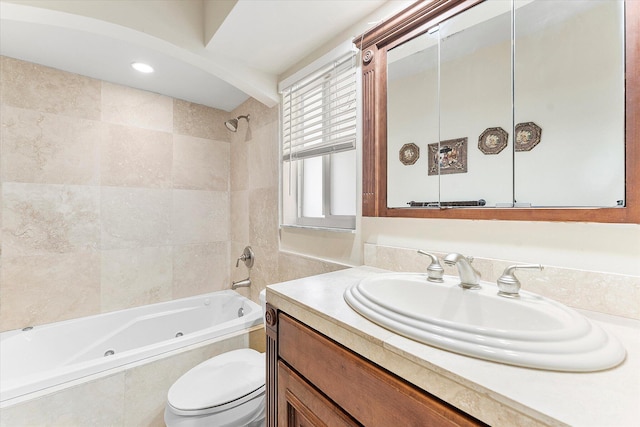 full bathroom with toilet, tiled shower / bath combo, and vanity