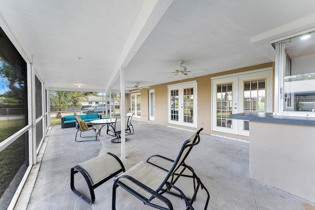 sunroom with ceiling fan and french doors