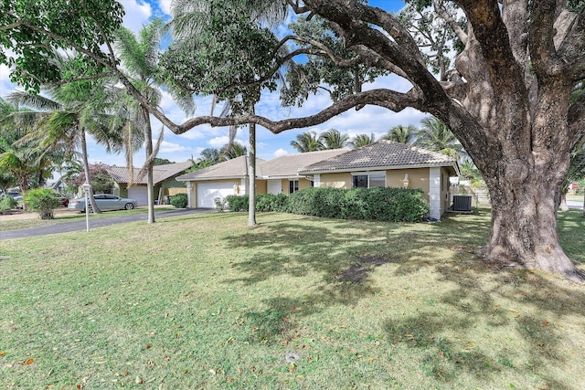 ranch-style house with a garage and a front yard