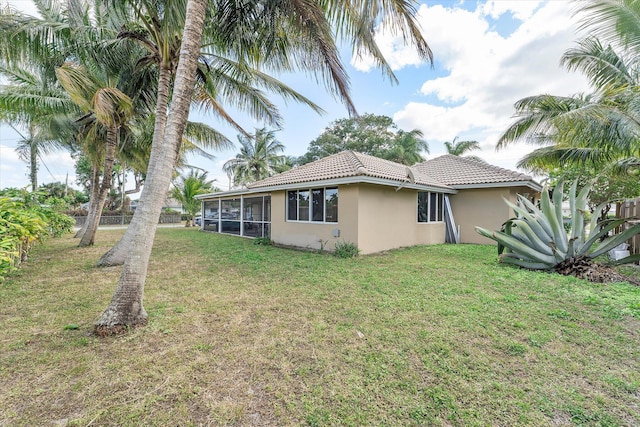 view of property exterior featuring a yard and a sunroom