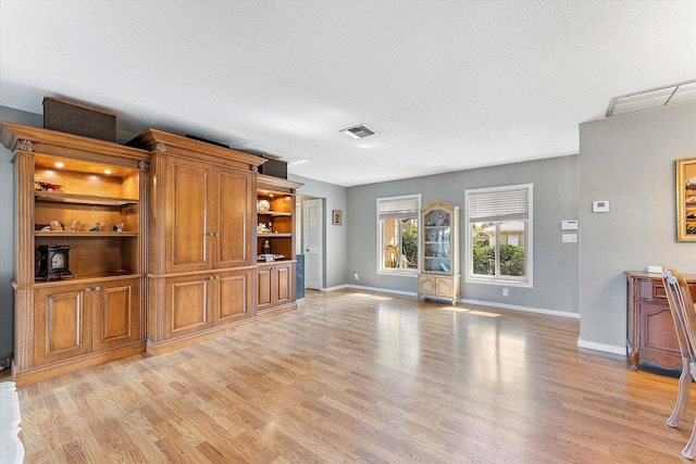 unfurnished living room featuring light hardwood / wood-style floors