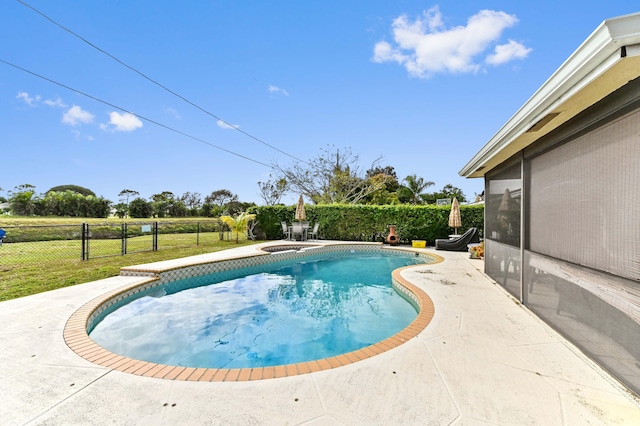 view of pool featuring a patio area and a yard