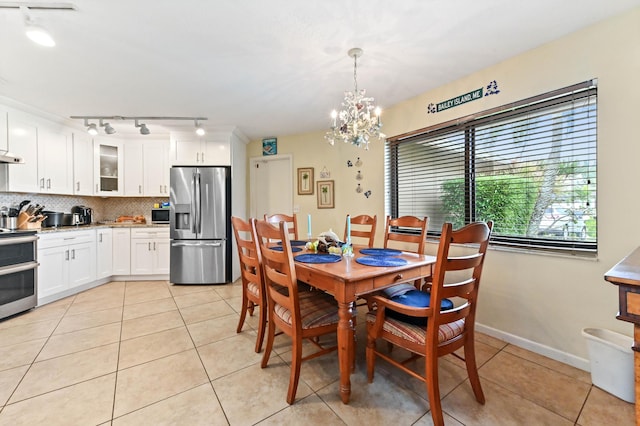 tiled dining space featuring an inviting chandelier