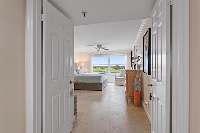 tiled bedroom featuring ceiling fan and ornamental molding