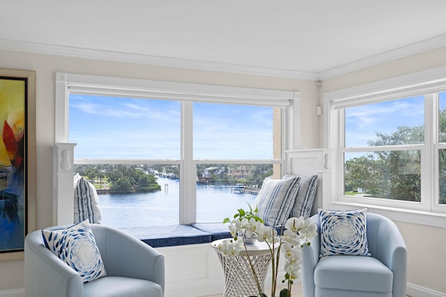 living area with ornamental molding and a water view