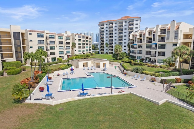 view of swimming pool featuring a patio and a lawn