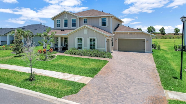 view of front of house with a garage and a front yard