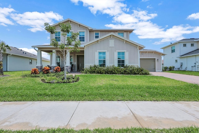 view of front of home featuring a garage, a porch, and a front yard