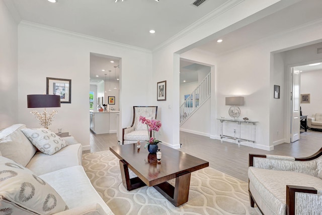 living room featuring light wood-type flooring and ornamental molding