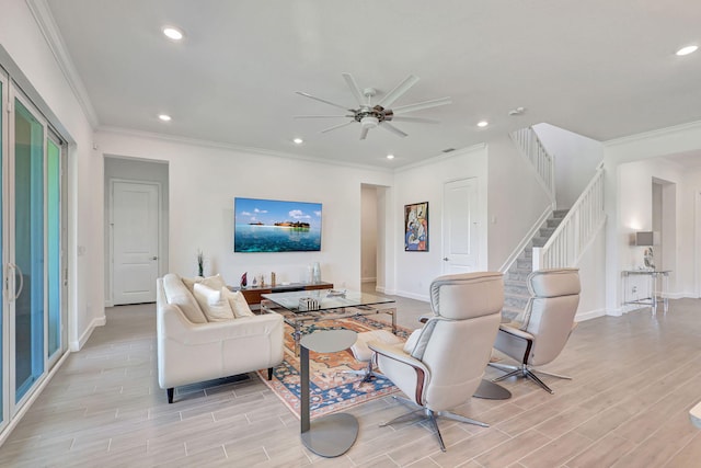 living room with ceiling fan and ornamental molding