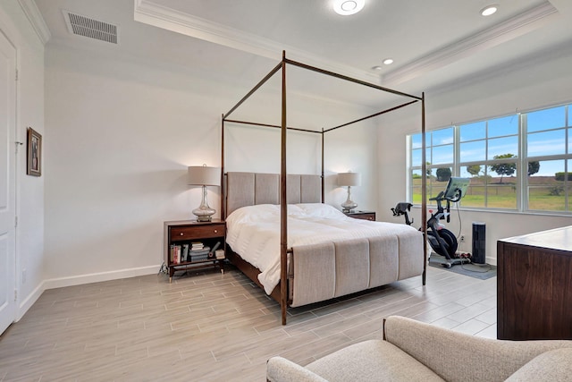 bedroom featuring a raised ceiling and ornamental molding