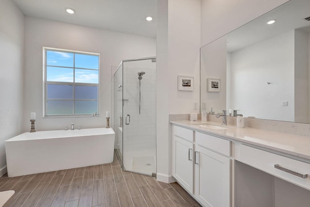 bathroom featuring vanity and shower with separate bathtub