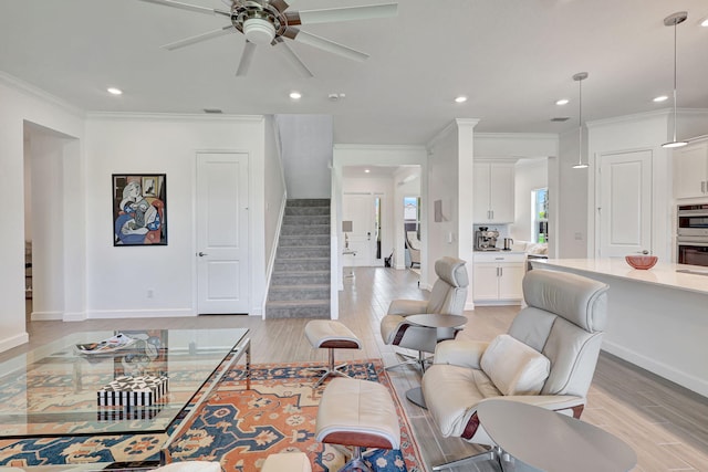 living room featuring ceiling fan, crown molding, and light hardwood / wood-style floors