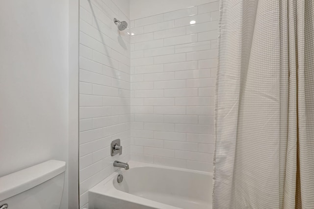 bathroom with toilet and shower / bath combination with curtain