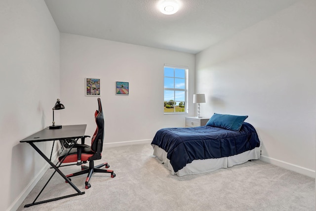 carpeted bedroom featuring a textured ceiling