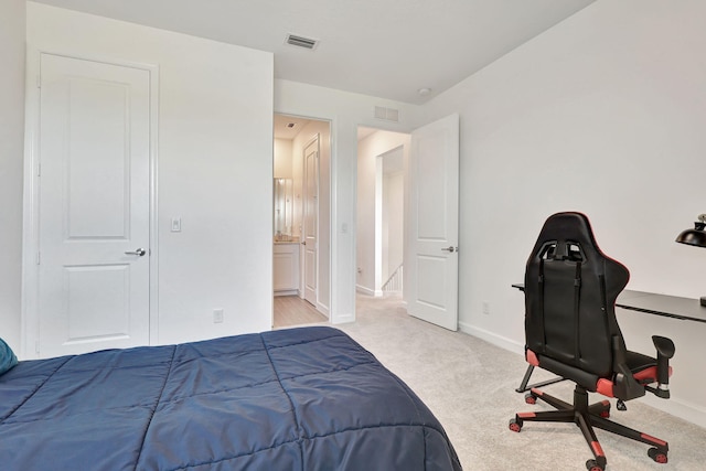 carpeted bedroom featuring ensuite bathroom