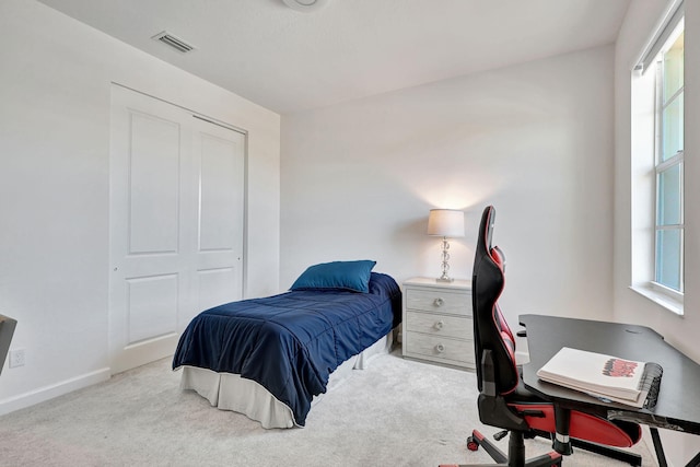 carpeted bedroom with multiple windows