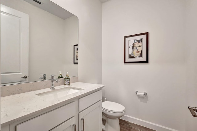 bathroom featuring toilet and vanity