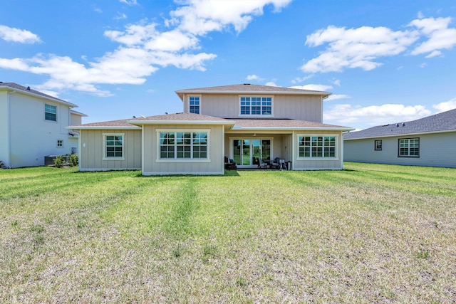 back of property featuring a lawn