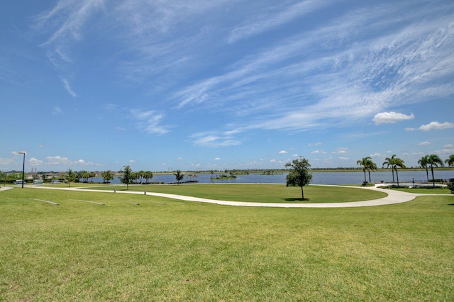 view of home's community featuring a water view and a yard