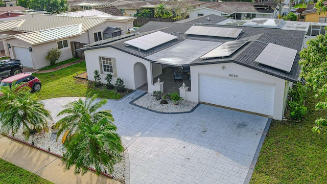 view of front of house featuring solar panels and a garage