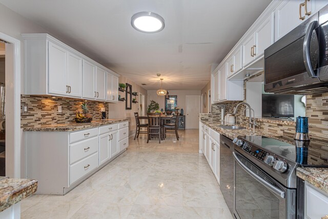 kitchen with white cabinetry, backsplash, hanging light fixtures, stainless steel electric range, and sink