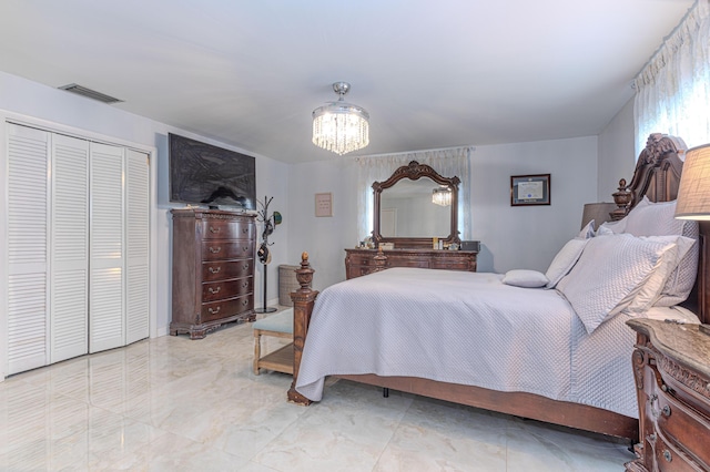 bedroom with a closet and a notable chandelier