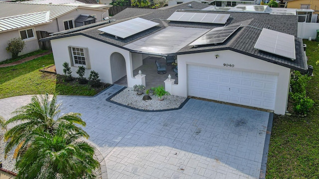 view of front of home with a garage and solar panels