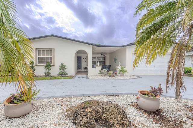 view of front of property with ceiling fan and a garage