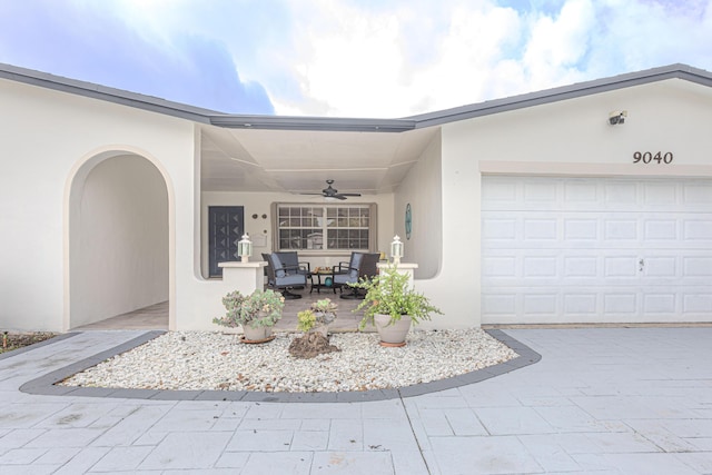 property entrance with ceiling fan and a garage