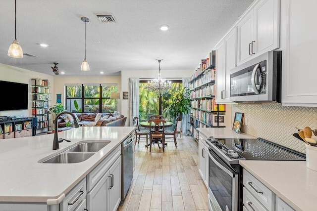 kitchen featuring sink, white cabinetry, and appliances with stainless steel finishes