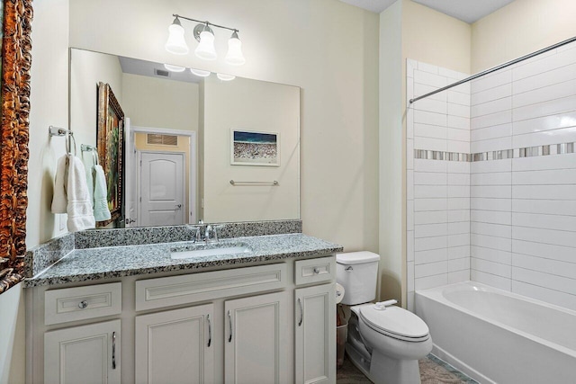 full bathroom featuring toilet, vanity, and tiled shower / bath combo