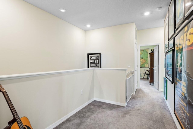 hall with light colored carpet