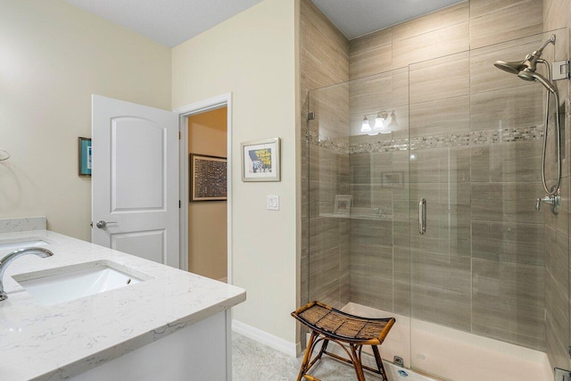 bathroom with vanity and a shower with shower door