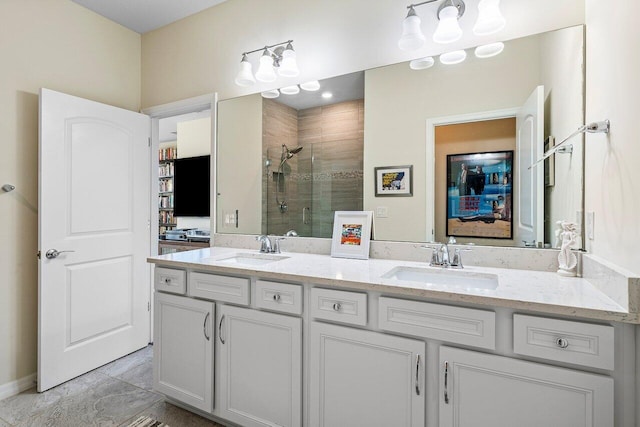 bathroom with walk in shower and vanity