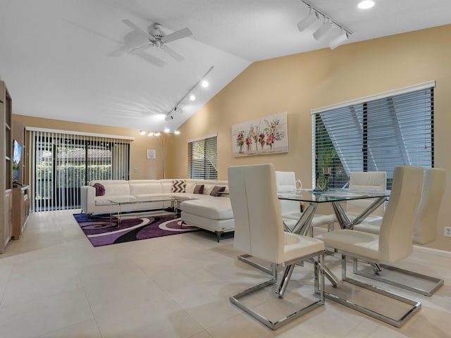 dining room featuring ceiling fan, lofted ceiling, and light tile patterned floors